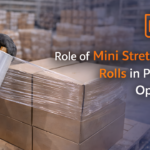 Worker using mini stretch wrap roll to secure boxes in Africa warehouse packaging and logistics operations