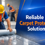 Worker applying carpet protection film in Africa construction site to protect flooring during industrial and renovation projects